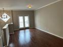 Bright living room featuring hardwood floors, neutral walls, and a diamond accent window at 3015 Liberty Nw Way, Atlanta, GA 30318