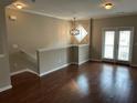 Open-concept living room featuring hardwood floors, neutral walls, and a modern chandelier at 3015 Liberty Nw Way, Atlanta, GA 30318