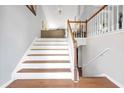 Interior shot of wooden stairs with white risers and railing leading to upper floor at 3383 Spirit Nw Dr, Kennesaw, GA 30144