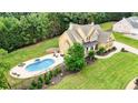 Aerial view of a traditional two-story home featuring a backyard pool and lush landscaping at 116 Archstone Sq, Mcdonough, GA 30253