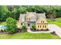 Charming two-story home with a well-manicured lawn, complemented by lush landscaping, and featuring a backyard pool at 116 Archstone Sq, Mcdonough, GA 30253