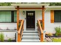 Beautiful front entry featuring a modern black door, wooden accents, and landscaped surroundings at 1981 Shalimar Ne Dr, Atlanta, GA 30345