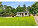 Charming single-story home with a well-manicured front yard, carport, and inviting curb appeal at 1981 Shalimar Ne Dr, Atlanta, GA 30345