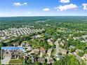 Community aerial view showcasing a neighborhood with mature trees, community pool, and a glimpse of the featured home at 5157 Sunlake Dr, Hoschton, GA 30548