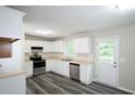 Bright kitchen featuring white cabinets, stainless steel appliances, and hardwood flooring at 52 Tide Water Way, Rockmart, GA 30153
