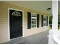 Inviting front porch showcasing black front door, neutral siding, white trim, and pleasant natural light at 52 Tide Water Way, Rockmart, GA 30153