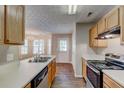 Well-lit kitchen with stainless steel appliances, wood cabinets, and a view into the dining area at 2289 Strathmoor Manor Dr, Lithonia, GA 30058