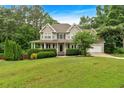 Charming two-story home with a welcoming front porch and manicured landscaping at 345 Riverstone Dr, Hiram, GA 30141
