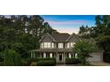 Charming two-story home with a welcoming front porch and manicured landscaping at 345 Riverstone Dr, Hiram, GA 30141