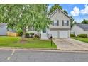 Charming two-story home featuring neutral siding, black shutters, two-car garage, and a well-manicured front lawn at 4435 Grove Nw Dr, Acworth, GA 30101