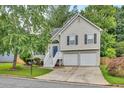 Charming two-story home featuring neutral siding, black shutters, two-car garage, and a well-manicured front lawn at 4435 Grove Nw Dr, Acworth, GA 30101