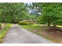 Long driveway leading to a well-maintained home with mature trees and manicured lawn at 217 Cedar Trl, Jonesboro, GA 30238
