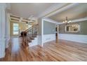 Elegant living room with hardwood floors, coffered ceilings, fireplace, and ample natural light at 7804 Gusty Trl, Douglasville, GA 30135