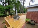 Wooden deck area with outdoor seating and lush greenery at 1177 Baker Ln, Marietta, GA 30062