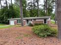 A charming brick home sitting on a lot covered in mature trees at 1177 Baker Ln, Marietta, GA 30062