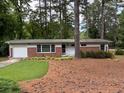 Charming brick home with well-maintained lawn and mature trees at 1177 Baker Ln, Marietta, GA 30062