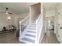 Bright entryway with a staircase, light wood floors, and a view of the living room at 3185 Perch Sw Dr, Marietta, GA 30008
