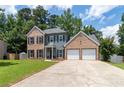 Charming two-story home boasts a mix of brick and siding with a two-car attached garage at 3185 Perch Sw Dr, Marietta, GA 30008