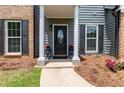 Close-up of the front door area featuring decorative columns and potted flowers at 3185 Perch Sw Dr, Marietta, GA 30008