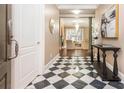 Welcoming foyer featuring a black and white checkered floor that leads into a bright and inviting living area at 3280 Stillhouse Se Ln # 108, Atlanta, GA 30339