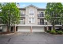 Townhouse with multiple balconies and garages offering a blend of style and functionality at 4248 River Green Nw Dr # 310, Atlanta, GA 30327