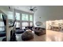 Bright and airy living room featuring high ceilings, a fireplace, and an open layout leading to the kitchen at 1245 Cedar Oak Ln, Lawrenceville, GA 30043