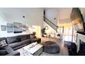Open living room showcasing a soaring ceiling, modern decor, and luxury vinyl flooring at 1245 Cedar Oak Ln, Lawrenceville, GA 30043