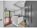 A modern kitchen with stainless steel appliances and granite countertops, flowing into an open living area at 1250 Parkwood Se Cir # 1213, Atlanta, GA 30339