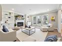 Beautifully staged living room with fireplace, built-in bookshelves, and bright, natural light at 4271 Weston Sw Dr, Lilburn, GA 30047