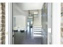 Inviting foyer with dark wood flooring, staircase and plenty of natural light at 2649 Ogden Trl, Buford, GA 30519