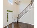 Bright foyer features a staircase with decorative iron railing and hardwood floors at 11100 Chandon Way, Johns Creek, GA 30097