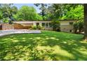 Well-manicured lawn and lush greenery surrounding a charming one-story home at 1492 Sagewood Cir, Stone Mountain, GA 30083