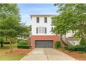 Traditional two-story house with brick base, white siding, dark shutters, and a driveway to the garage at 4228 Laurel Creek Se Ct # 6, Smyrna, GA 30080