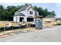 Two-story home construction featuring large windows and an attached two-car garage at 723 Crest Line Trl, Powder Springs, GA 30127
