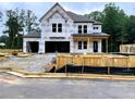 Two-story home construction featuring large windows and an attached two-car garage at 723 Crest Line Trl, Powder Springs, GA 30127