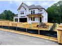 Two-story home construction featuring large windows and an attached two-car garage at 723 Crest Line Trl, Powder Springs, GA 30127