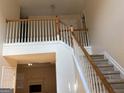 Staircase with carpeted steps, white railings, and natural light filtering into the home at 7981 Gossamer Dr, Fairburn, GA 30213