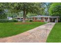 Traditional single-story brick home featuring a long driveway and mature shade trees at 2858 Valley Ridge Dr, Decatur, GA 30032