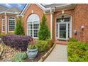 A home's front entrance surrounded by lush landscaping and a pathway to the front door at 333 Lauren Ln, Woodstock, GA 30188