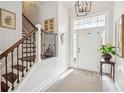 Bright foyer with staircase featuring hardwood stairs, and a striking light fixture at 333 Lauren Ln, Woodstock, GA 30188