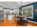 Bright kitchen featuring stainless steel appliances, an island, and a cozy breakfast nook at 638 Glen Valley Way, Dacula, GA 30019