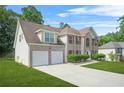 Brick home on a large lot with a two car garage and traditional shutters on the windows at 6799 Hill Creek Cv, Lithonia, GA 30058