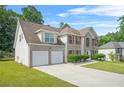 Brick home on a large lot with a two car garage and traditional shutters on the windows at 6799 Hill Creek Cv, Lithonia, GA 30058