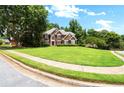 Charming two-story home with lush green lawn and well-maintained landscaping at 194 Lake Ruby Dr, Suwanee, GA 30024