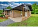 Side view of the brick home showcasing the attached carport at 370 Walnut St, Social Circle, GA 30025