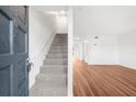 Open living space with stairs, wood floors, and neutral paint for versatile decorating at 382 Northdale Ct, Lawrenceville, GA 30046