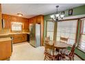 Cozy kitchen featuring wood cabinetry, stainless steel appliances, and a charming breakfast nook at 402 Princeton Way, Lawrenceville, GA 30044
