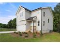 Beautiful two-story home with light siding, a two-car garage, and a well-manicured front yard at 4095 Oriole Ln, Fairburn, GA 30213