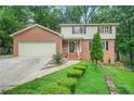Charming two-story brick home featuring a well-manicured lawn and inviting front porch at 574 Hickory Hills Ct, Stone Mountain, GA 30083