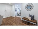 Welcoming entryway with hardwood floors, white door, and leather bench seating at 115 Biscayne Nw Dr # F10, Atlanta, GA 30309